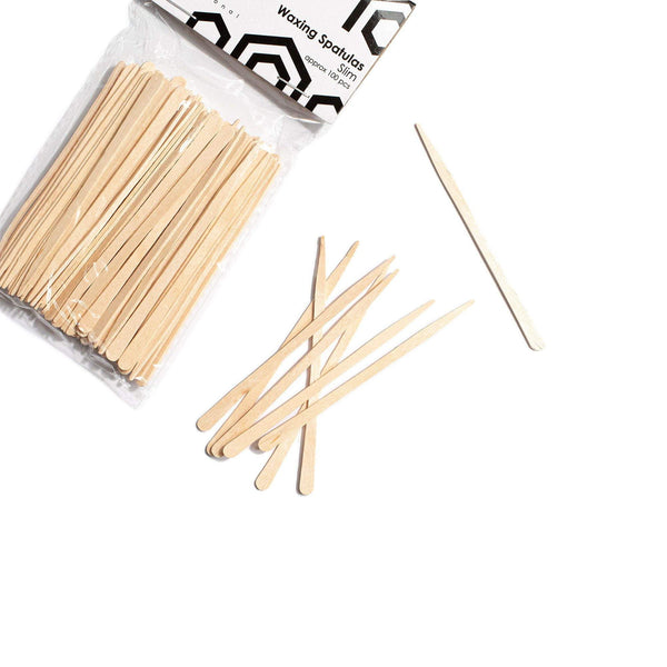 Slim Sticks (100): bag of thin wooden waxing sticks with loose sticks in front