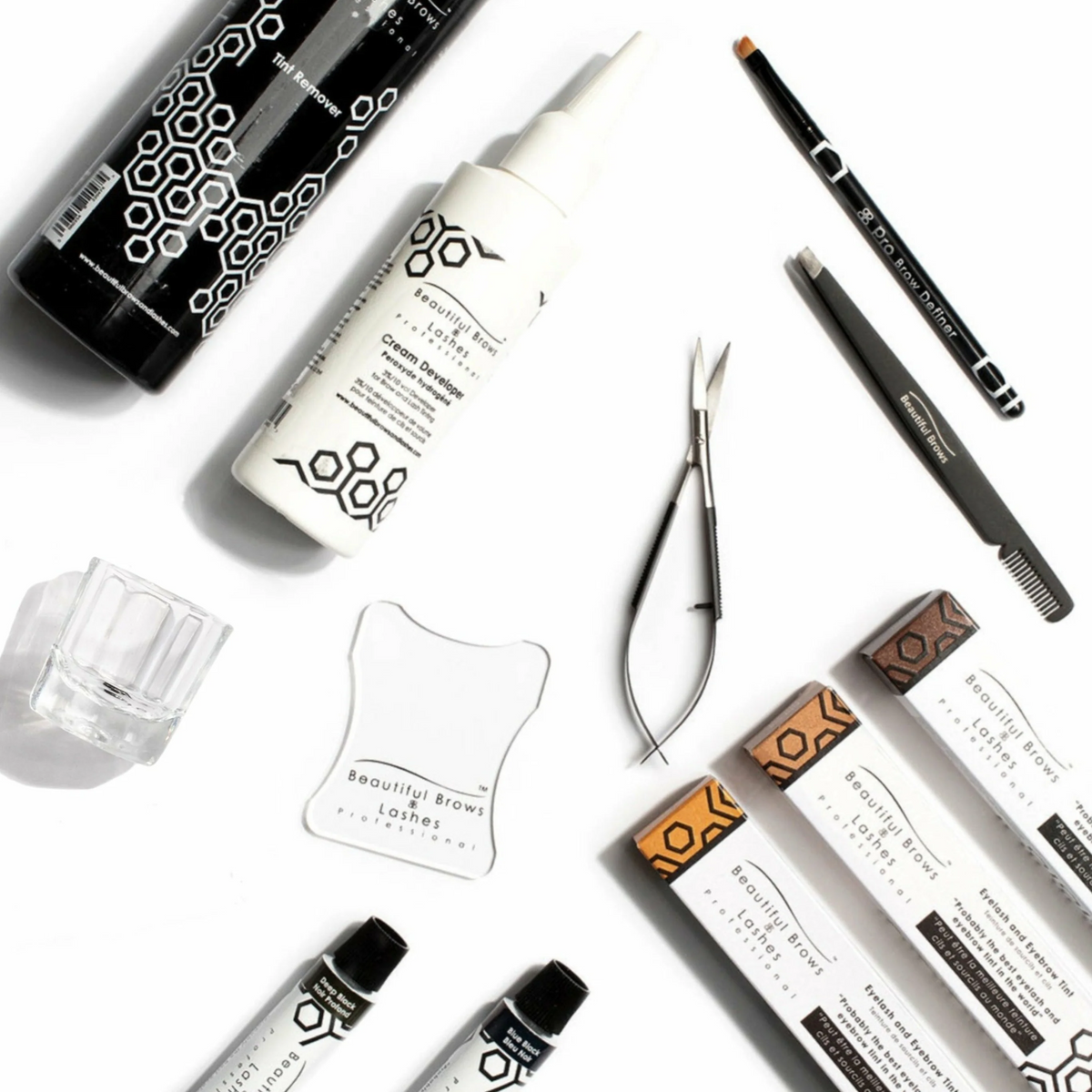 Pro Tint Pack tools: trimming scissors, tweezers, brow brush, eye guard, glass mixing cup, developer and tint